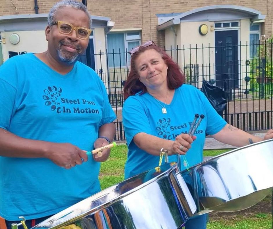 Steel Pan Class 2 people smiling at camera